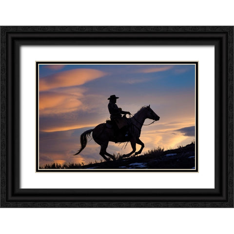 USA- Shell- Wyoming. Hideout Ranch cowboy on horseback silhouetted at sunset.  Black Ornate Wood Framed Art Print with Double Matting by Gulin, Darrell