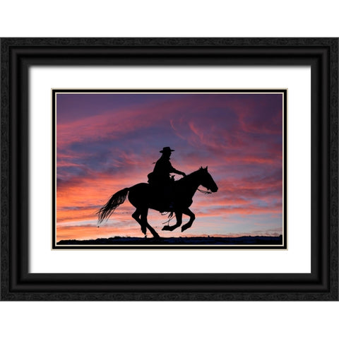USA- Shell- Wyoming. Hideout Ranch cowgirl silhouetted on horseback at sunset.  Black Ornate Wood Framed Art Print with Double Matting by Gulin, Darrell