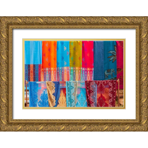 Laos- Luang Prabang. Colorful textiles- possibly scarves- for sale. Gold Ornate Wood Framed Art Print with Double Matting by Haseltine, Tom