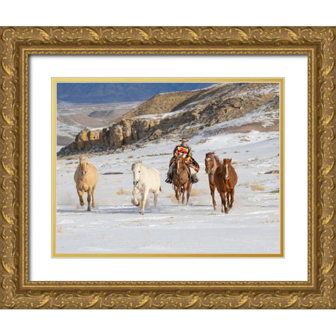 USA- Shell- Wyoming. Hideout Ranch cowboy riding and herding horses in snow.  Gold Ornate Wood Framed Art Print with Double Matting by Gulin, Darrell