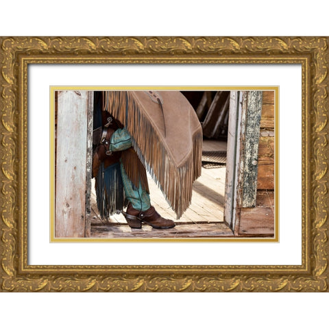 USA- Shell- Wyoming. Hideout Ranch cowgirl standing in doorway with cowboy boots and chaps.  Gold Ornate Wood Framed Art Print with Double Matting by Gulin, Darrell