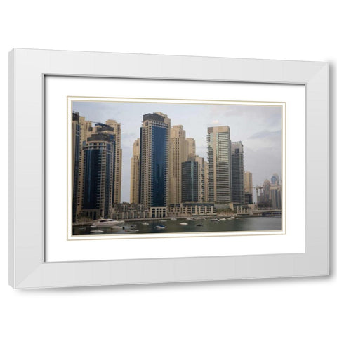 UAE, Dubai Modern buildings tower over boats White Modern Wood Framed Art Print with Double Matting by Young, Bill