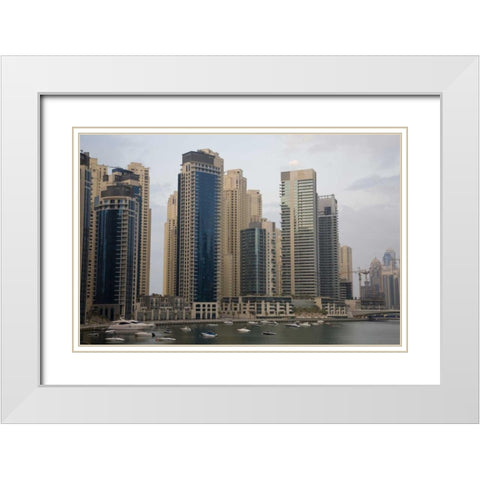 UAE, Dubai Modern buildings tower over boats White Modern Wood Framed Art Print with Double Matting by Young, Bill