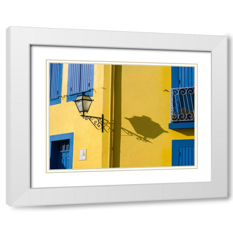 Portugal-Aveiro-Shadow of street lantern on colorful yellow building with bright blue shutters White Modern Wood Framed Art Print with Double Matting by Eggers, Julie