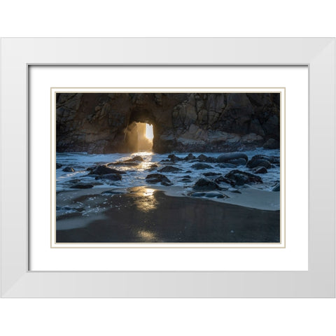 Sun shines through a tunnel in a sea cliff in the Big Sur area. White Modern Wood Framed Art Print with Double Matting by Sederquist, Betty