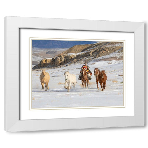 USA- Shell- Wyoming. Hideout Ranch cowboy riding and herding horses in snow.  White Modern Wood Framed Art Print with Double Matting by Gulin, Darrell