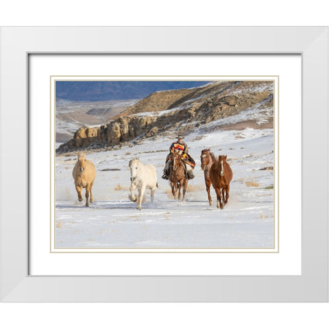 USA- Shell- Wyoming. Hideout Ranch cowboy riding and herding horses in snow.  White Modern Wood Framed Art Print with Double Matting by Gulin, Darrell