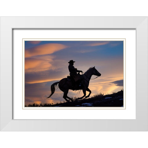 USA- Shell- Wyoming. Hideout Ranch cowboy on horseback silhouetted at sunset.  White Modern Wood Framed Art Print with Double Matting by Gulin, Darrell