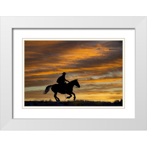 USA- Shell- Wyoming. Hideout Ranch cowgirl silhouetted on horseback at sunset.  White Modern Wood Framed Art Print with Double Matting by Gulin, Darrell