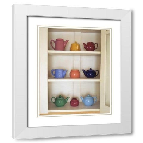Antique ceramic teapots and sugar bowls in cupboard White Modern Wood Framed Art Print with Double Matting by Terrill, Steve