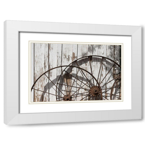 Old wagon wheels against a shed in Buffalo Gap Historic Village, near Abilene, TX White Modern Wood Framed Art Print with Double Matting by Highmith, Carol