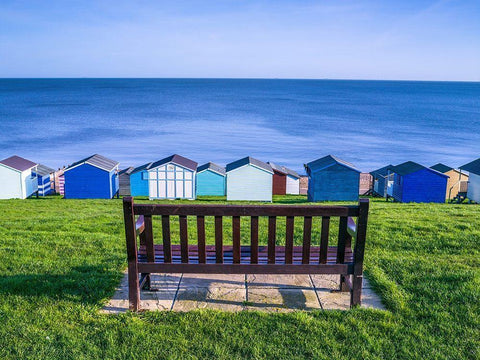 Bench on lawn with beach huts in background Black Ornate Wood Framed Art Print with Double Matting by Frank, Assaf