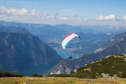 Austria-Dachstein-Paraglider soaring above Lake Hallstatt and the surrounding mountains White Modern Wood Framed Art Print with Double Matting by Looney, Hollice
