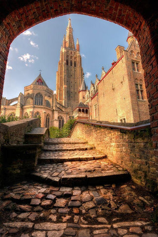 An arch leads to a church in Bruges-Belgium Black Ornate Wood Framed Art Print with Double Matting by Steve Mohlenkamp