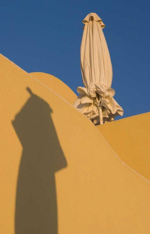 Greece, Santorini Sun umbrella against a wall Black Ornate Wood Framed Art Print with Double Matting by Young, Bill