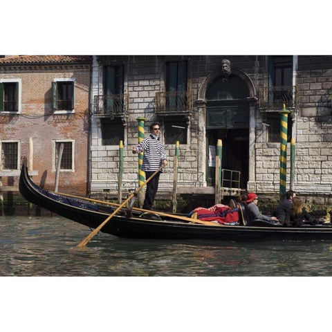 Italy, Venice A gondolier strikes a pose Black Modern Wood Framed Art Print by Kaveney, Wendy