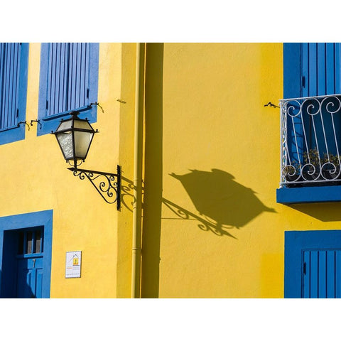 Portugal-Aveiro-Shadow of street lantern on colorful yellow building with bright blue shutters Black Modern Wood Framed Art Print by Eggers, Julie