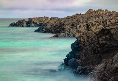 Lava rocks along tranquil shoreline of San Cristobal Island-Galapagos-Ecuador Black Ornate Wood Framed Art Print with Double Matting by Jones, Adam