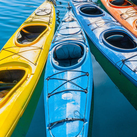 Four colorful kayaks positioned in an array. Black Modern Wood Framed Art Print by Muir, Janet