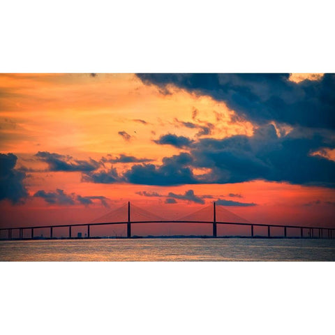 The Skyway Bridge over the Gulf of Mexico with the reds and oranges of the sunrise in the sky Black Modern Wood Framed Art Print with Double Matting by Haddad, Sheila