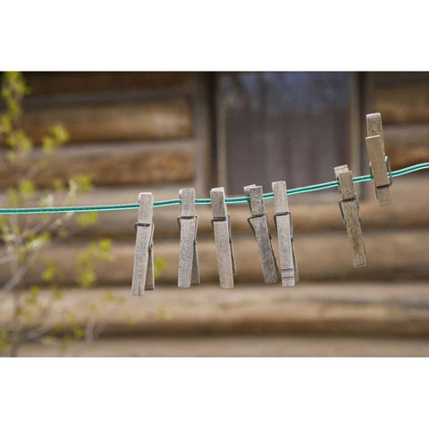 MT, Clothes pins on a clothesline by a log cabin Black Modern Wood Framed Art Print by Paulson, Don