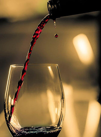 One drop shows as red wine is poured into glass White Modern Wood Framed Art Print with Double Matting by Duval, Richard
