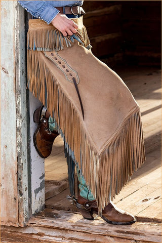 USA- Shell- Wyoming. Hideout Ranch cowgirl standing in doorway with cowboy boots and chaps.  Black Modern Wood Framed Art Print by Gulin, Darrell