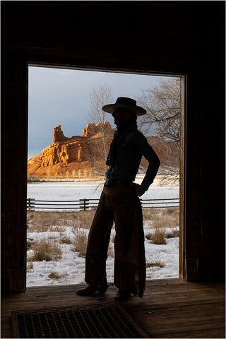 USA- Shell- Wyoming. Hideout Ranch with cowgirl silhouetted in doorway of log cabin.  White Modern Wood Framed Art Print with Double Matting by Gulin, Darrell