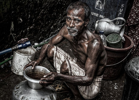 Man Filling A Pitcher With Water In The Streets Of Bangladesh. Black Ornate Wood Framed Art Print with Double Matting by Inazio Kuesta, Joxe