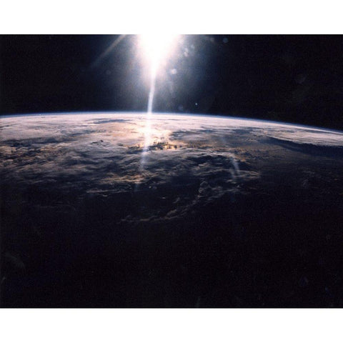 Sunlight over Earth as seen by Discovery crew Black Modern Wood Framed Art Print with Double Matting by NASA