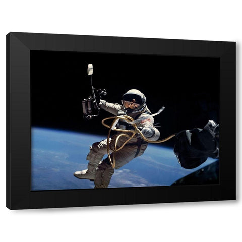 Astronaut Edward White during first EVA performed during Gemini 4 flight Black Modern Wood Framed Art Print with Double Matting by NASA