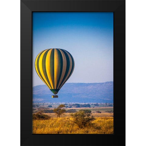 A hot-air balloon slowly traverses over the Serengeti plain Black Modern Wood Framed Art Print by Richardson, Larry