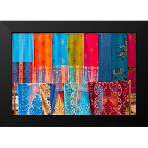 Laos- Luang Prabang. Colorful textiles- possibly scarves- for sale. Black Modern Wood Framed Art Print by Haseltine, Tom