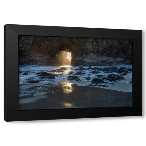 Sun shines through a tunnel in a sea cliff in the Big Sur area. Black Modern Wood Framed Art Print by Sederquist, Betty