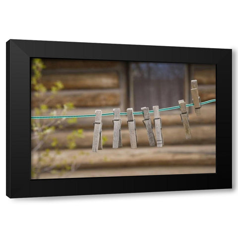 MT, Clothes pins on a clothesline by a log cabin Black Modern Wood Framed Art Print by Paulson, Don