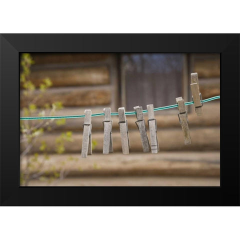 MT, Clothes pins on a clothesline by a log cabin Black Modern Wood Framed Art Print by Paulson, Don
