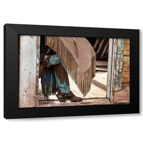USA- Shell- Wyoming. Hideout Ranch cowgirl standing in doorway with cowboy boots and chaps.  Black Modern Wood Framed Art Print with Double Matting by Gulin, Darrell