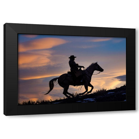 USA- Shell- Wyoming. Hideout Ranch cowboy on horseback silhouetted at sunset.  Black Modern Wood Framed Art Print by Gulin, Darrell