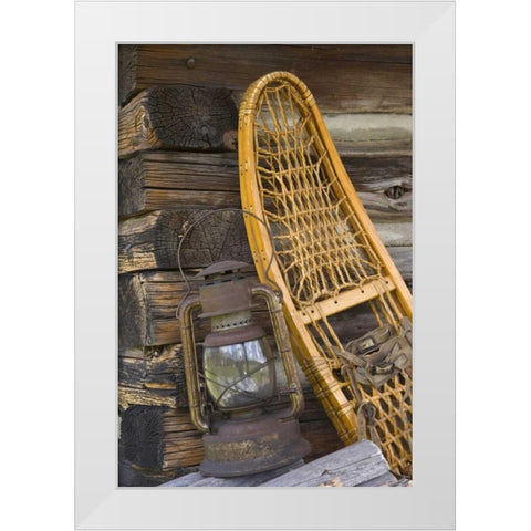 MT, A lantern and snowshoe outside a log cabin White Modern Wood Framed Art Print by Paulson, Don
