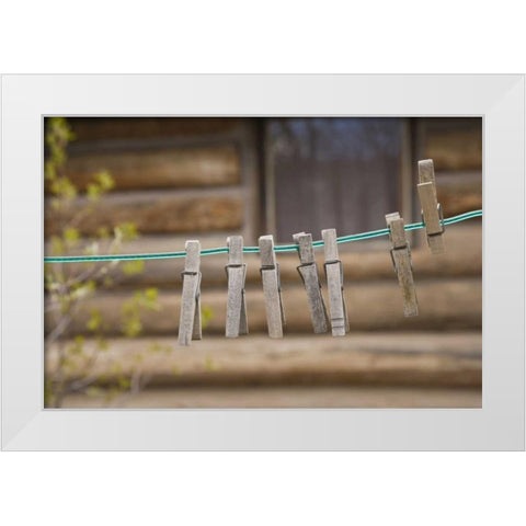 MT, Clothes pins on a clothesline by a log cabin White Modern Wood Framed Art Print by Paulson, Don