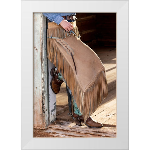 USA- Shell- Wyoming. Hideout Ranch cowgirl standing in doorway with cowboy boots and chaps.  White Modern Wood Framed Art Print by Gulin, Darrell