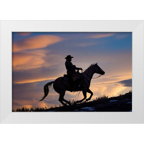 USA- Shell- Wyoming. Hideout Ranch cowboy on horseback silhouetted at sunset.  White Modern Wood Framed Art Print by Gulin, Darrell